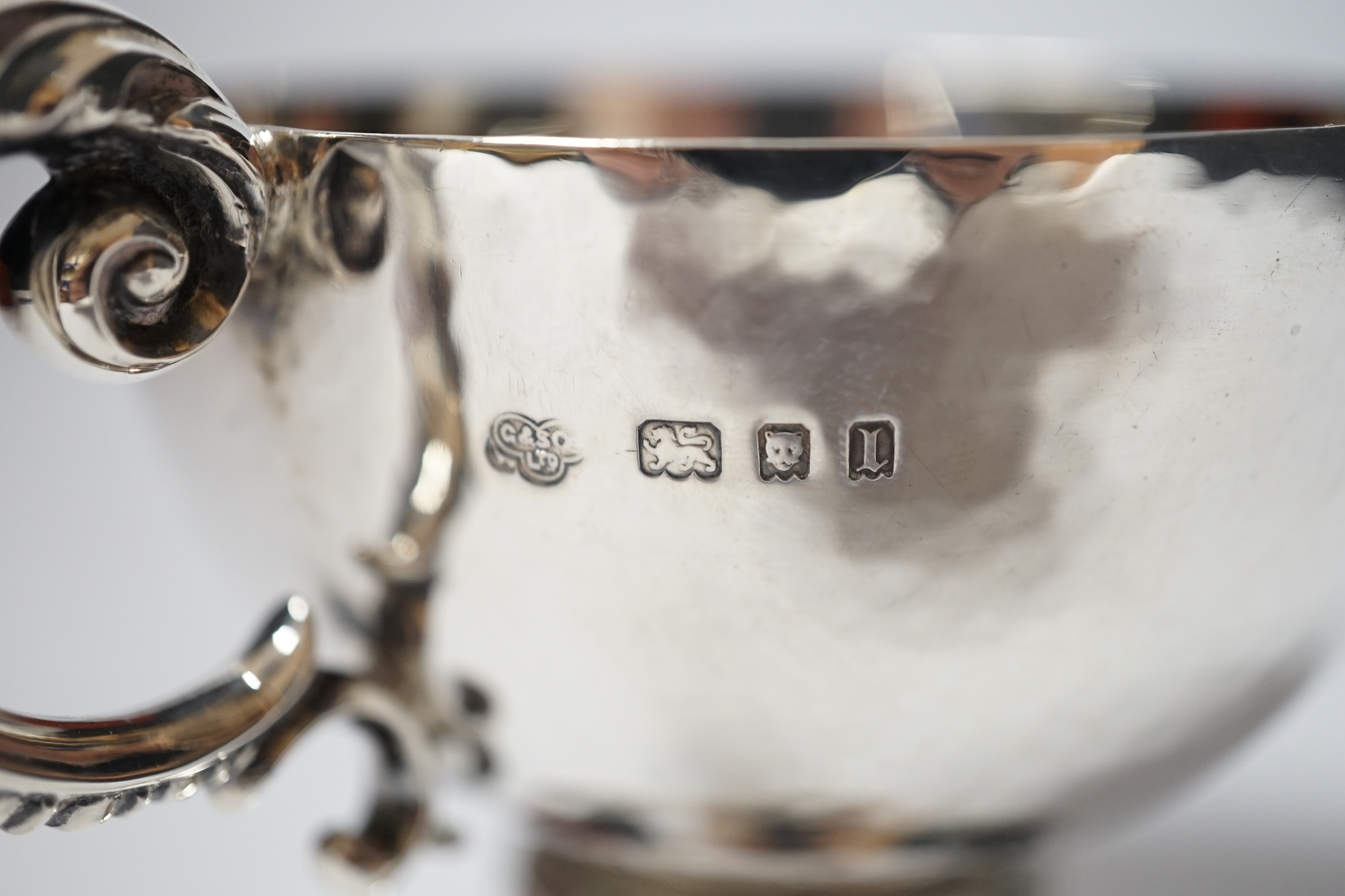 A George V planished silver pedestal single handled cup, Goldsmiths & Silversmiths Co Ltd, London, 1926, 86mm, 5.9oz.